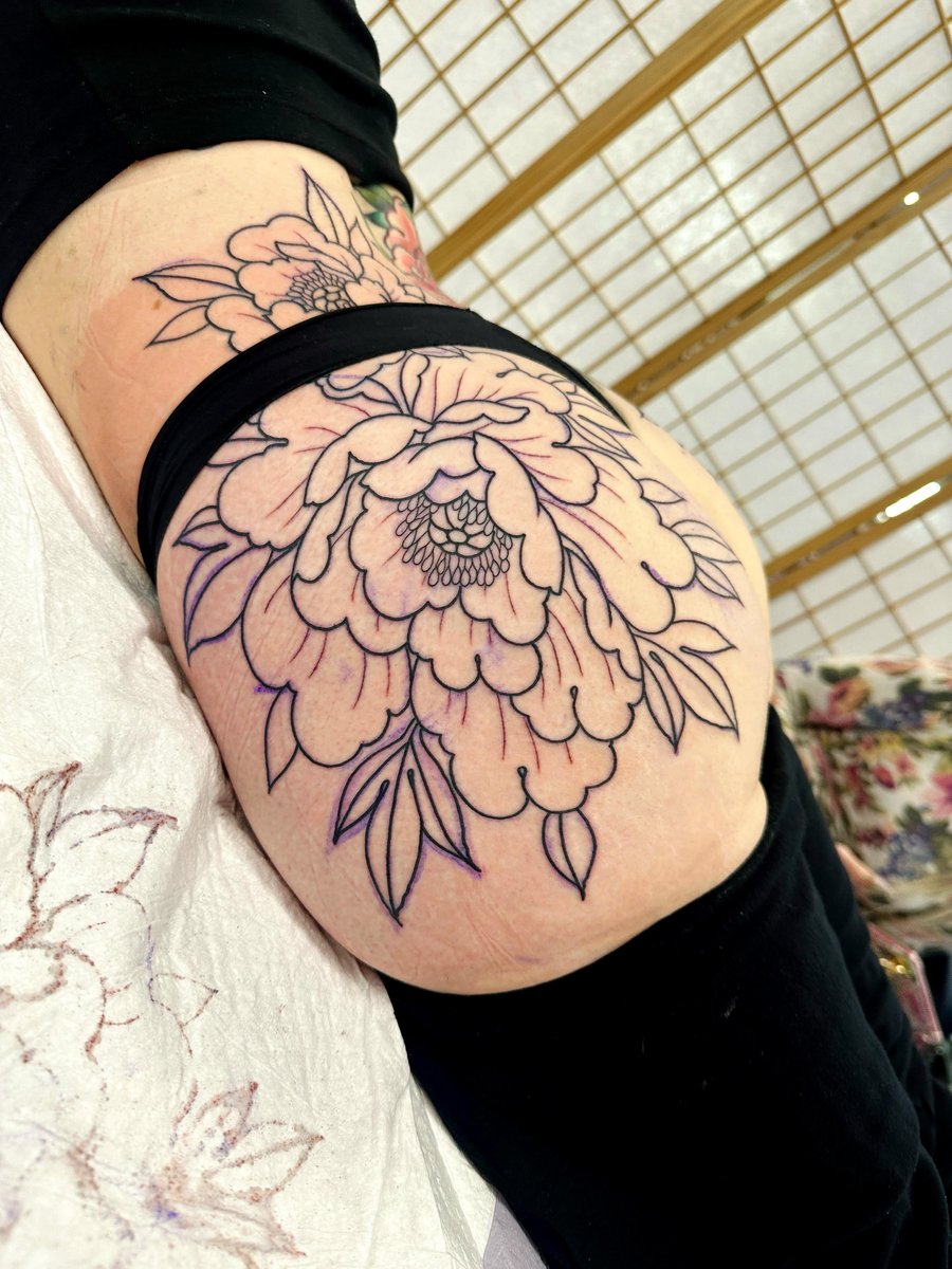 Photo of the tattoo titled Lower back and butt flower tattoo
