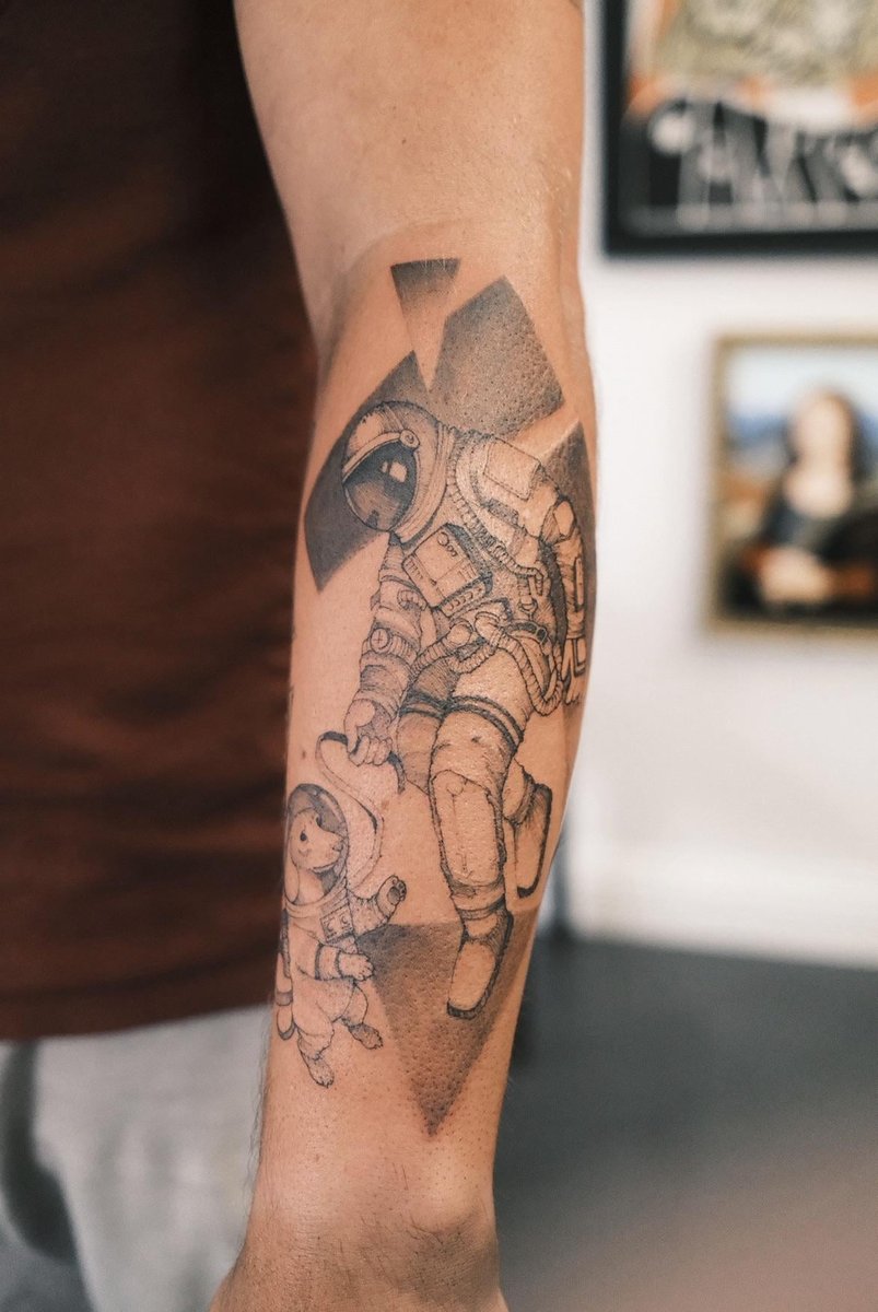 Photo of the tattoo titled Astronaut and Dog's Cosmic Walk
