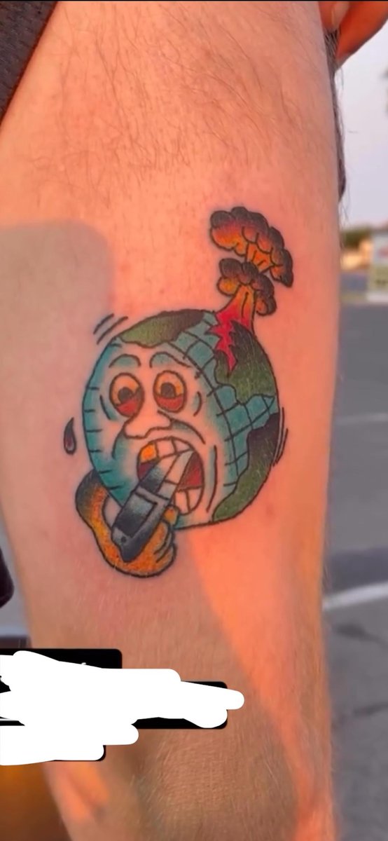 Photo of the tattoo titled Earth with Gun Tattoo
