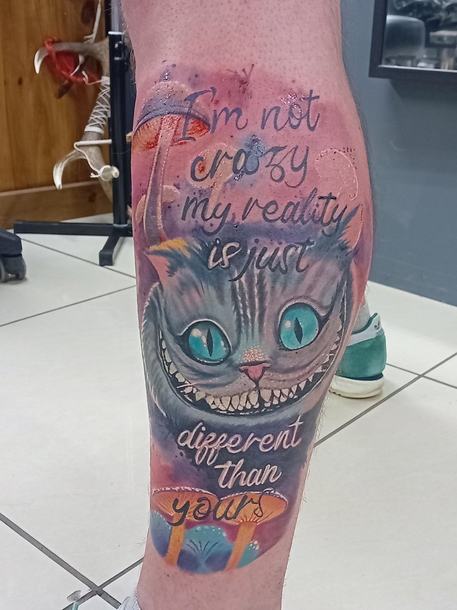 Photo of the tattoo titled Cheshire Cat Grin