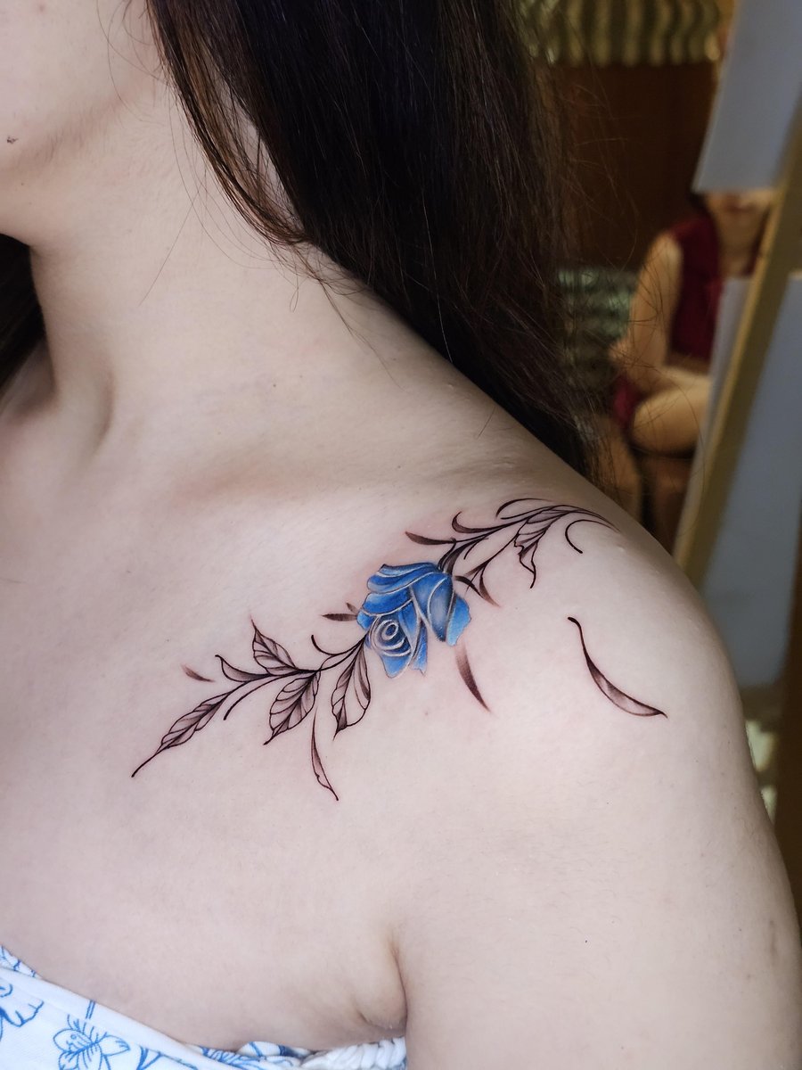 Photo of the tattoo titled Elegant Blue Rose Collarbone Tattoo