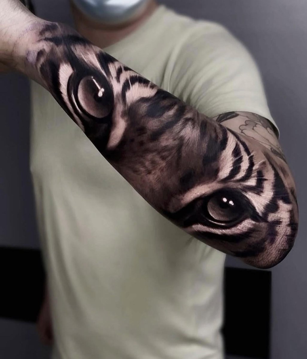 Photo of the tattoo titled Black and Grey Tiger Eyes Sleeve