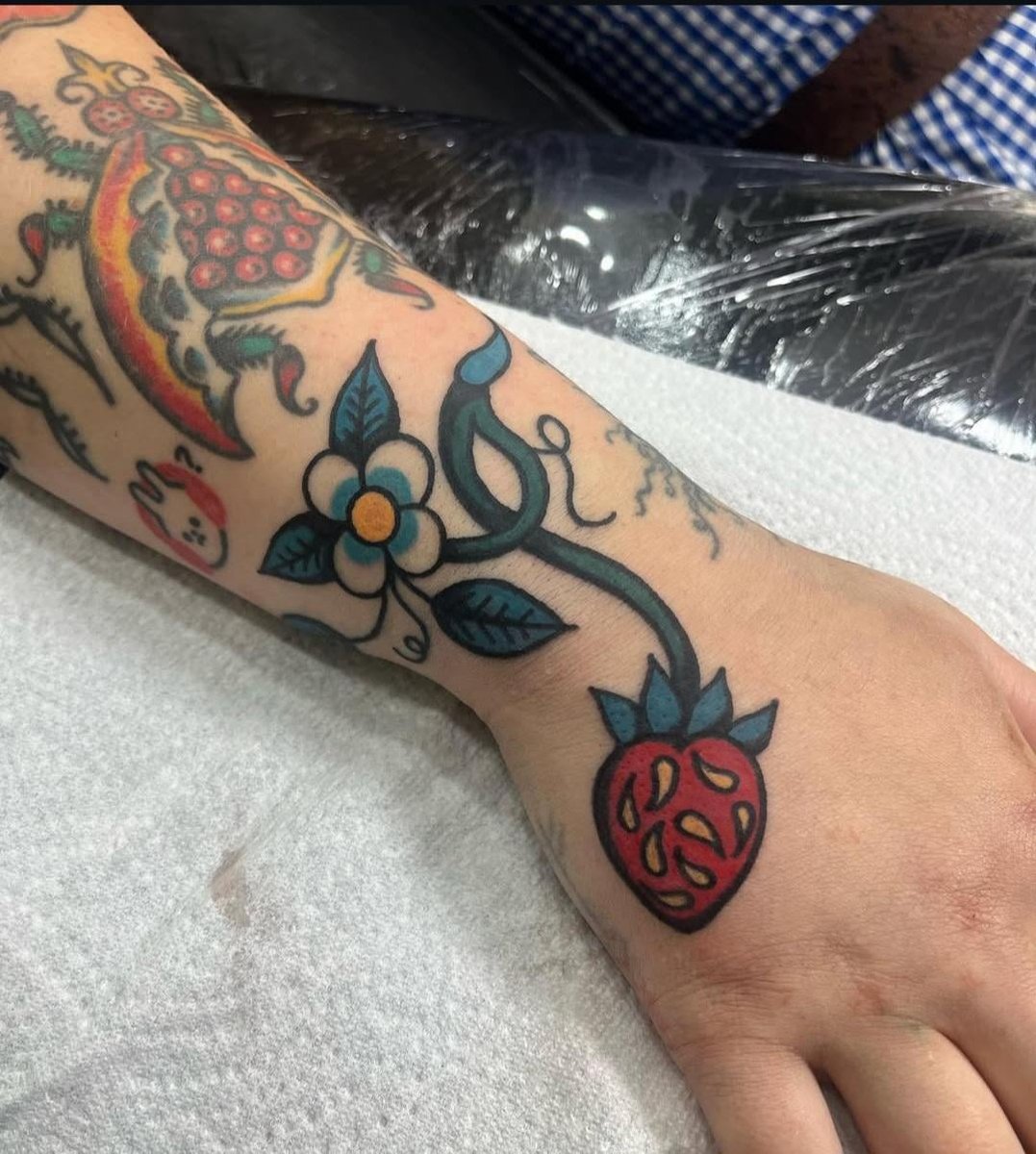 Photo of the tattoo titled Funky Hand Banger Pomegranate Fly