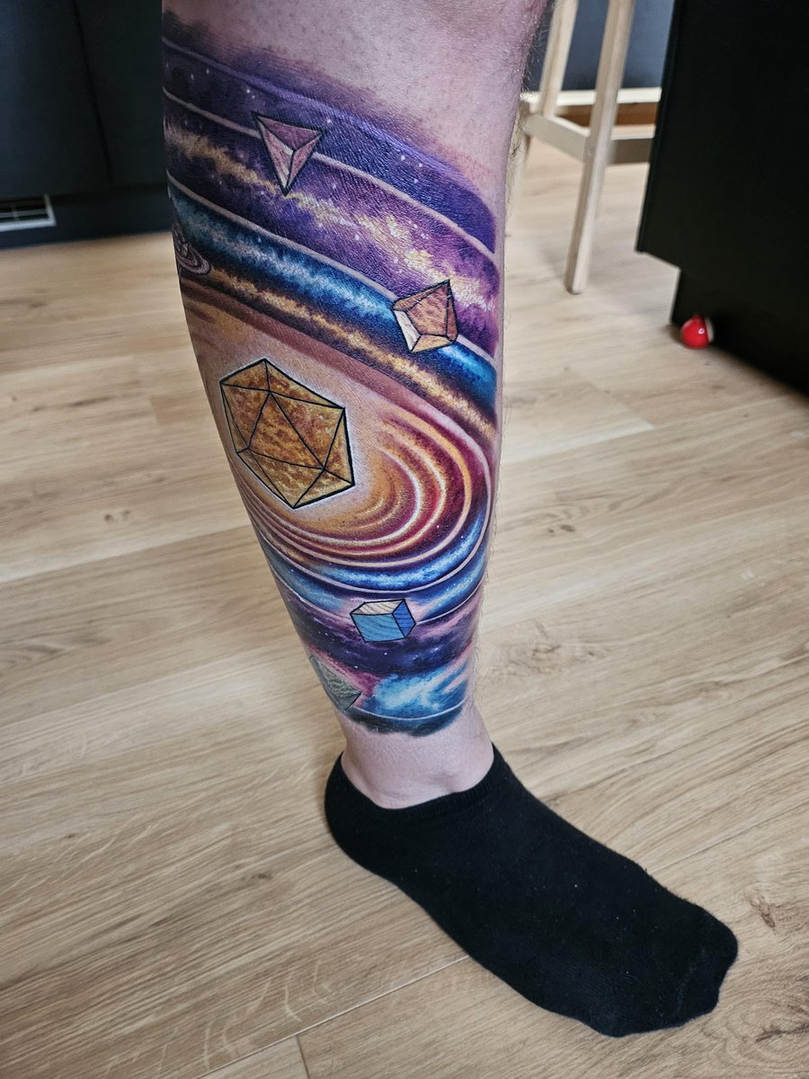 Photo of the tattoo titled Tabletop RPG Dice Planets