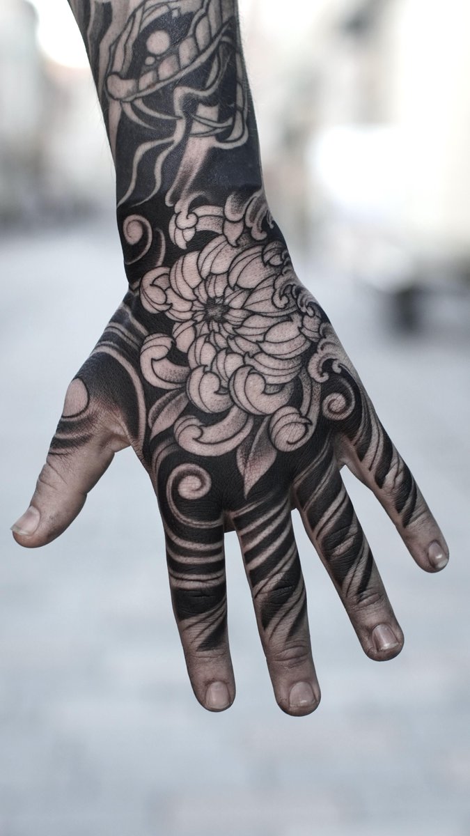 Photo of the tattoo titled Bold Blackwork Chrysanthemum Hand Piece